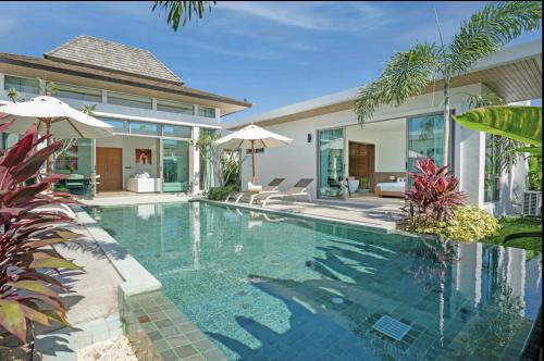 a swimming pool in the backyard of a villa at SHAMBHALA GRAND Pool Villas x MonthStayZ Thailand in Phuket
