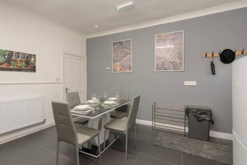 a dining room with a table and chairs at Family-Friendly 2-Bed Home with Games & Fireplace in Colne