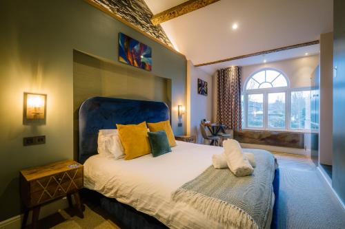 a bedroom with a large bed and a window at Craig's Suites Windermere in Windermere