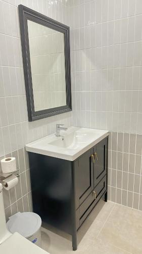a bathroom with a sink and a toilet and a mirror at Chaisona at Khanom Storey in Ban Phaeng
