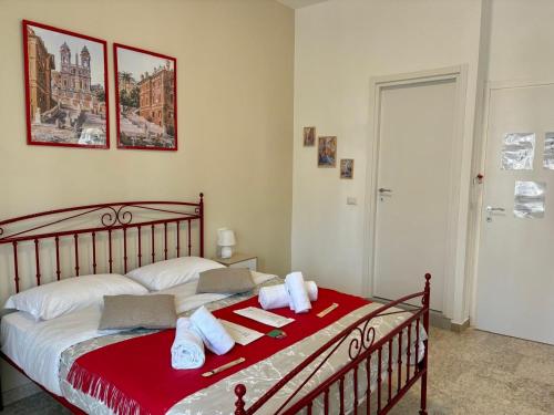 a bedroom with a bed with red and white towels at Quattro Venti city suites in Rome