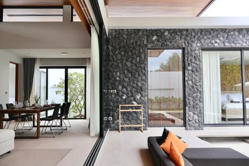 a living room with a couch and a table at Botanica - Bali Style Luxury 3 BR Private Pool Villa in Ban Pak Lak