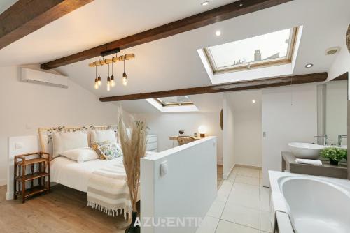 a bedroom with a bed and a bathroom with a sink at Azurenting - Maison Césario - 3 chambres in Cannes