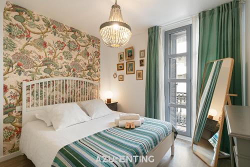 a bedroom with a bed with a floral wall at Azurenting - Maison Césario - 3 chambres in Cannes