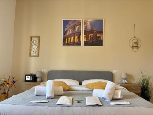 a bedroom with a large bed with towels on it at Quattro Venti city suites in Rome