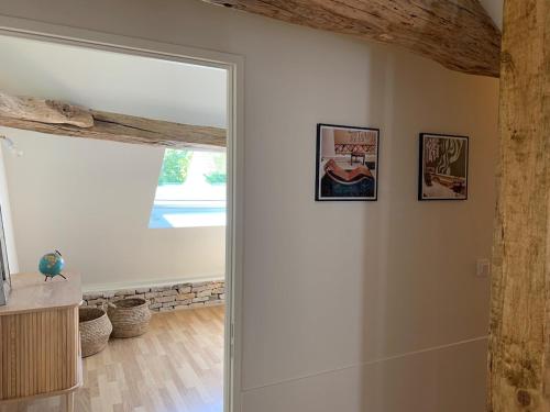 a door in a room with two pictures on the wall at L'Annexe Deveney-Mars in Puligny-Montrachet