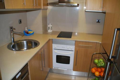 a kitchen with a sink and a white oven at AmurResidence free parking in Iaşi