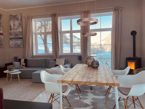 a living room with a table and a couch at Chalet Alpenlicht in Oberstdorf
