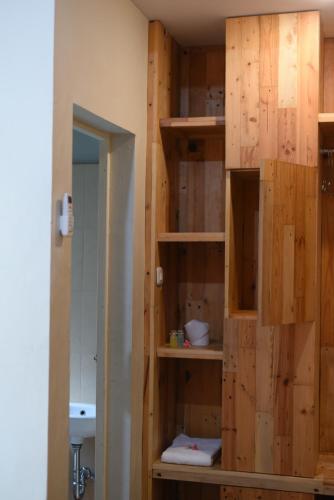 a bathroom with wooden walls and a toilet in a room at Roemah 28 Syariah in Medan