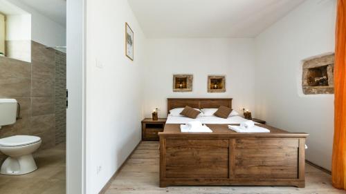 a bathroom with a bed and a toilet at Villa Katja by Villas Guide in Peruški