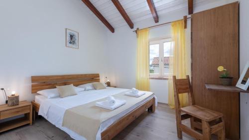 a bedroom with a bed with two towels on it at Villa Katja by Villas Guide in Peruški