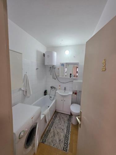 a bathroom with a tub sink and a toilet at Apartman Daki in Vareš