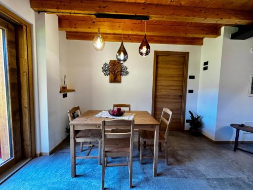 a dining room with a wooden table and chairs at Rosetta - Ai Meli - Dolomites in Lozzo Cadore