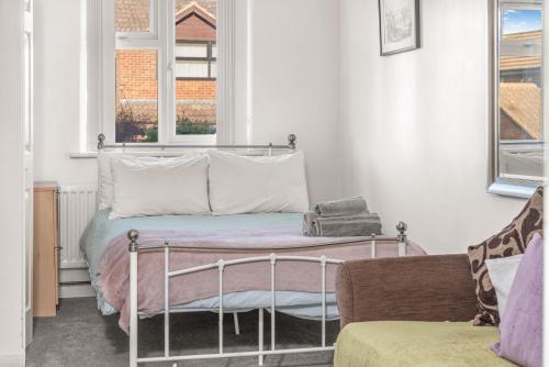 a bedroom with a bed and a couch at Badger Haven, Apartment 1 in Brackley