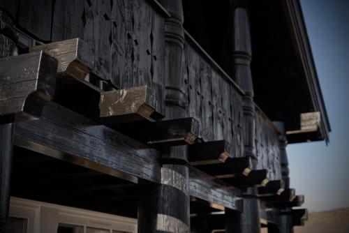 a group of wooden signs on the side of a building at Great mountain cabin with 12 beds in Vågsli