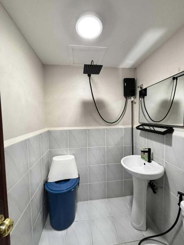 a bathroom with a toilet and a sink at Cozee Staycations in Lapu Lapu City