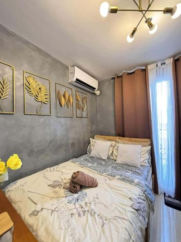 a bedroom with a bed with a hat on it at Cozee Staycations in Lapu Lapu City