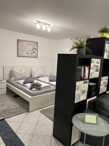 a bedroom with a bed and a book shelf at Ferienwohnung „ Zum Josefstal „ in Sankt Ingbert