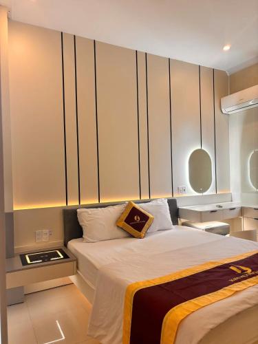 a bedroom with a bed with a pillow on it at Phú Quốc STAR hotel in Phú Quốc