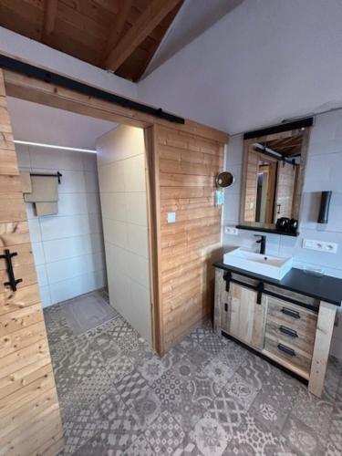 a bathroom with a sink and a shower and a mirror at Casa Laryssiou in Gythio