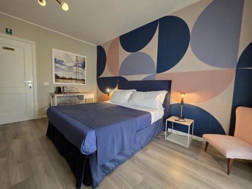 a bedroom with a large bed with a colorful wall at Guest House Seataly - by Be Your Home in Civitavecchia