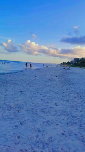 a group of people on a sandy beach at Verde & Sal 13 in Ilhéus