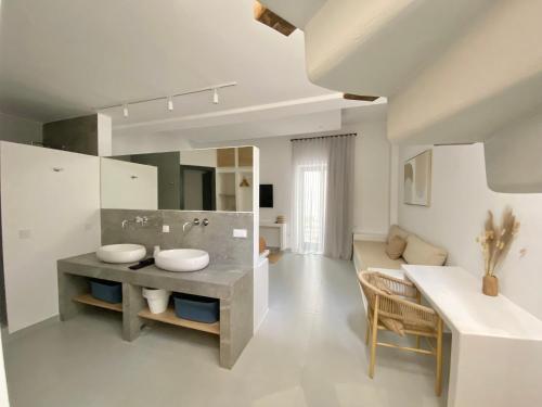 a bathroom with a sink and a large mirror at GBR 1 - Golden Beach Residences in Chrissi Akti