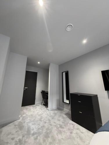 an empty room with a bed and a desk in it at 2 bedroom APT in City Centre in Manchester