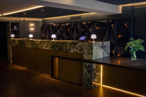 a bar in a hotel lobby with a stone counter at Best Western Abbots Barton Hotel in Canterbury