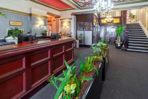 a lobby of a hotel with a bar with plants at The Savoy Hotel in Blackpool