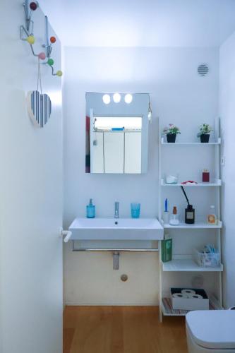 a bathroom with a sink and a mirror at Bloom - Beach House in Apúlia