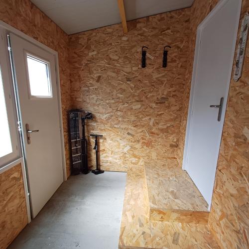 a room with a stone wall and a door at Villa Ptit Rene in Dunkerque