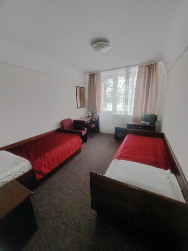 a hotel room with two beds and a window at Motel Poltava in Poltava