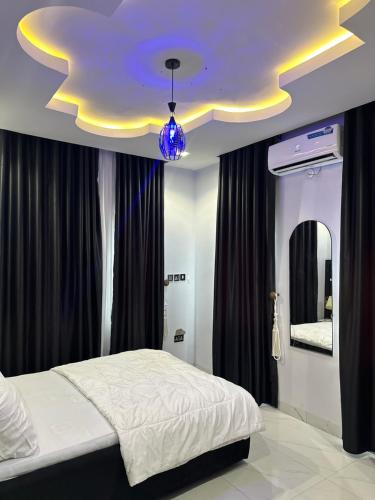 a bedroom with a bed and a purple ceiling at The NookHouse in Calabar