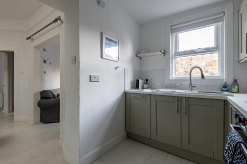a kitchen with a sink and a window at Bakers Close - Elie in Elie