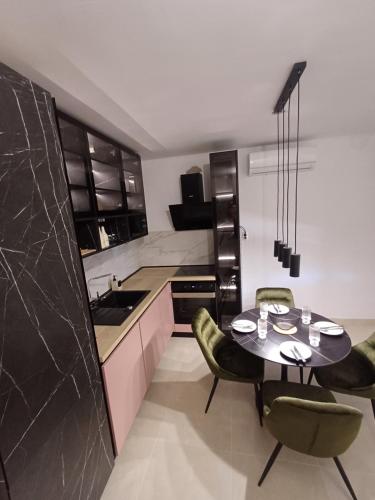 a kitchen with a table and chairs in a room at Apartman Danijel in Bibinje
