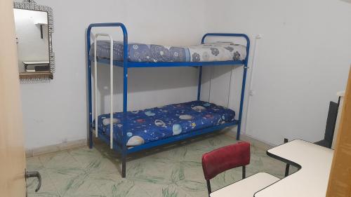 two bunk beds in a room with a mirror at Graciana Quequén in Necochea