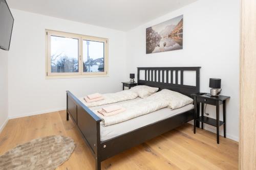 a bedroom with a bed and two night stands at Danube Tower holiday in Vienna