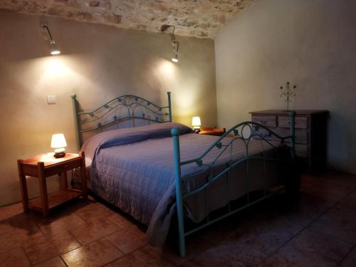a bedroom with a bed and two night stands at Gîte Côté Sud in Vagnas