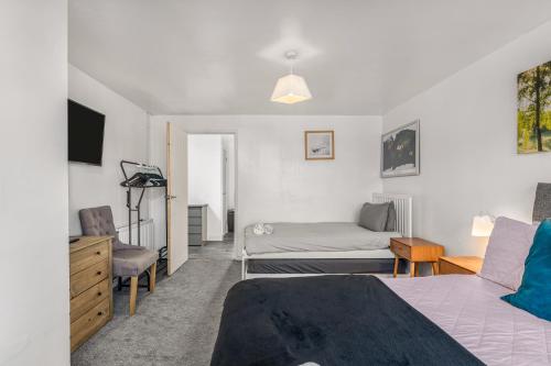 a bedroom with a bed and a couch at Badger Haven, Apartment 2 in Brackley