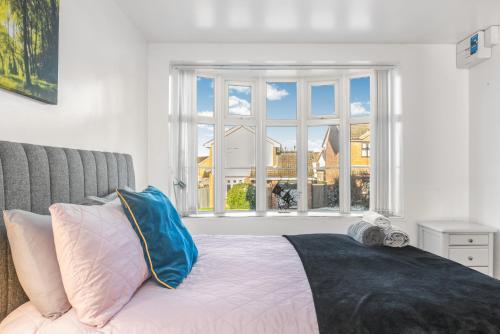a bedroom with a bed with a large window at Badger Haven, Apartment 2 in Brackley