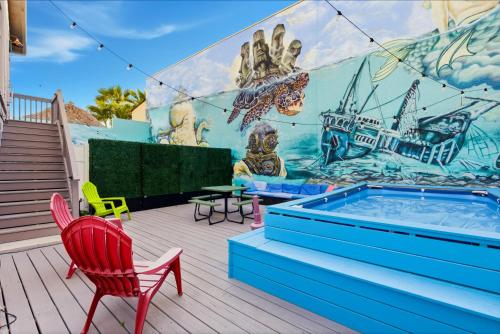 a patio with a swimming pool and a mural at MERMAID HOUSE WITH POOL JACUZZI STEPS to SIESTA KEY BEACH in Sarasota