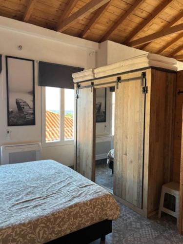 a bedroom with a bed with a wooden frame at Casa Laryssiou in Gythio