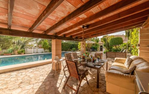 a patio with a couch and a table next to a pool at Can Taco in Galilea