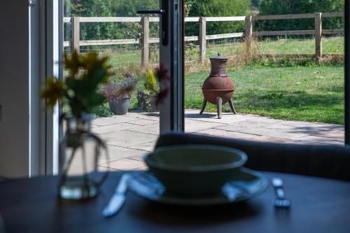 a vase sitting on a table in front of a window at Lakeside Lodge in Eastleigh