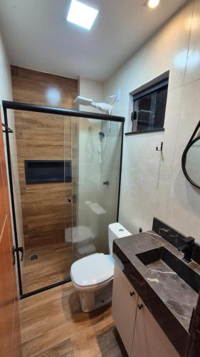 a bathroom with a toilet and a shower and a sink at Apt 18 - VR Village in São Luís