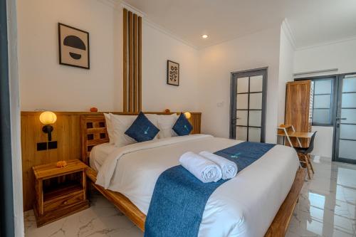 a bedroom with a large bed with towels on it at Little Soho Pererenan in Canggu