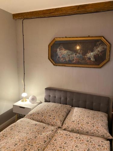 a bedroom with a bed with a picture on the wall at Kleine Auszeit in Oderberg