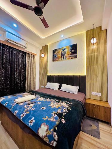 a bedroom with a bed and a ceiling fan at Urban Luxury Studio Apartment in Greater Noida