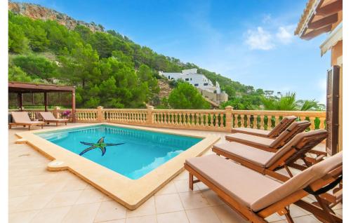a swimming pool on a deck with chairs and a house at Torre De Heretat in Canyamel